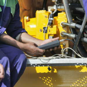 Technician performing periodic engine maintenance